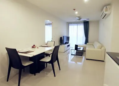a living room with a table and chairs and a couch at Sea view apartment at The Unity by Lofty in Patong Beach