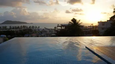 a large swimming pool with a view of the ocean at Sea view apartment at The Unity by Lofty in Patong Beach