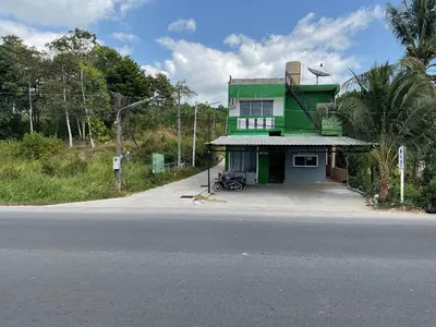 a green house sitting on the side of a road at Bangreen Naiyang Hotel in Nai Yang Beach