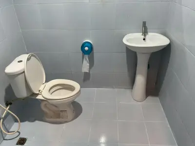 a bathroom with a toilet and a sink at Bangreen Naiyang Hotel in Nai Yang Beach