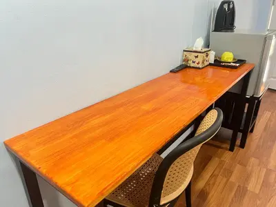 a wooden table with two chairs in a room at Koh Yao unnrak Resort in Ban Lo Pla Lai (1)