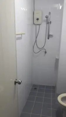 a small bathroom with a shower and a toilet at the three pyramids in Phuket Town