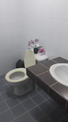 a bathroom with a toilet and a sink at the three pyramids in Phuket Town
