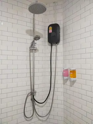 a shower with a shower head on a wall at Bonanza Patong Beach1 100m to Beach Moon Room in Patong Beach