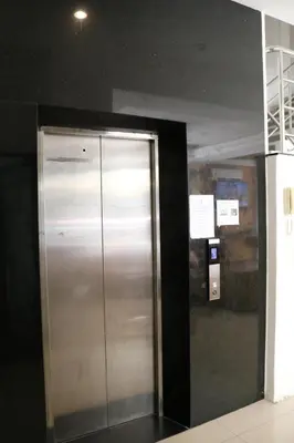 a metal elevator in a room with a black wall at Diamond Crown in Patong Beach