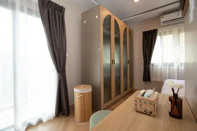 a living room with a table and a chair at Tuna Boutique Hotel Patong in Patong Beach