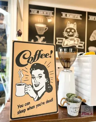 a sign on a counter with a coffee sign on it at Pim's Bed and Breakfast @ Phuket in Ban Bang Khu