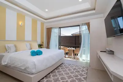 a bedroom with a large bed and a large window at Pure Bliss Luxe 3BR Pool Villa Your Ultimate Tropical Getaway V29 V74 in Bang Tao Beach