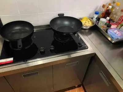 two pans sitting on top of a stove in a kitchen at beautiful pool house in Patong Beach
