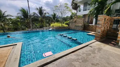 a swimming pool in front of a house at Plus condominium 2 kathu in Kathu