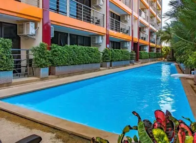 a large blue swimming pool in front of a building at Nai Harn NBC 1 BR in Rawai Beach