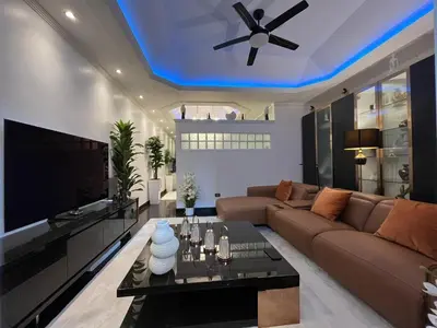 a living room with a couch and a ceiling fan at New 1 bed condo, very best central area, Patong in Patong Beach