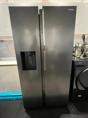 a stainless steel refrigerator in a kitchen next to a counter at New 1 bed condo, very best central area, Patong in Patong Beach