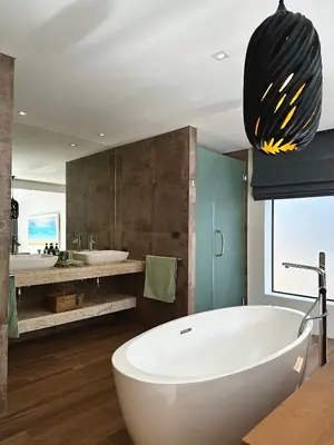 a bathroom with a large white tub and a sink at Villa Amata in Phuket Town
