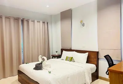 a bedroom with a bed with white sheets at Aonang Peace Pool Villa in Ban Khlong Haeng