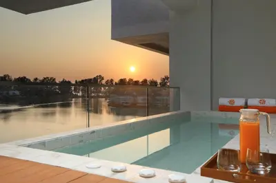 a swimming pool with a sunset in the background at 2bdr Lakeview Apartment Angsana oceanview residence by Capital Pro in Bang Tao Beach