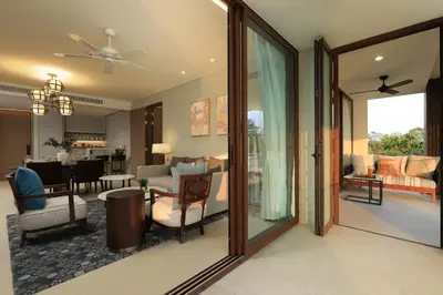 a living room with glass doors and a dining room at 2bdr Lakeview Apartment Angsana oceanview residence by Capital Pro in Bang Tao Beach