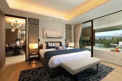 a large bedroom with a large bed and a desk at 2bdr Lakeview Apartment Angsana oceanview residence by Capital Pro in Bang Tao Beach