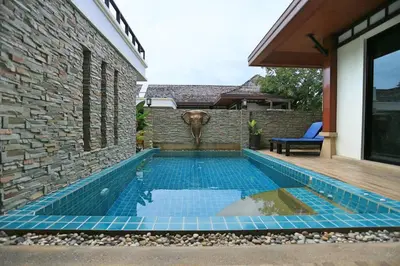 a swimming pool in the backyard of a house at Rawai VIP 2D2 Tow-bedroom villa in Phuket Town