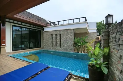 a swimming pool in the backyard of a house at Rawai VIP 2D2 Tow-bedroom villa in Phuket Town