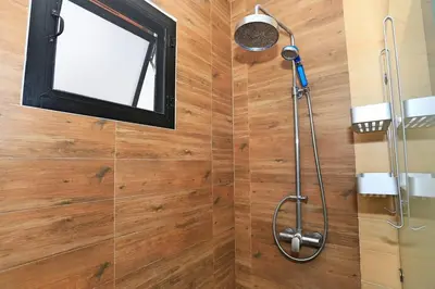 a bathroom with a shower with a window at Rawai VIP 2D2 Tow-bedroom villa in Phuket Town