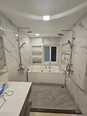 a white bathroom with a tub and a sink at Castle Villa Phuket in Kamala Beach