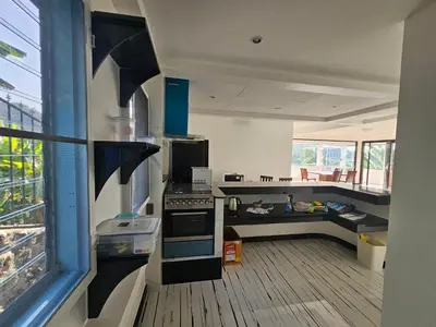 a kitchen with a stove top oven next to a window at Castle Villa Phuket in Kamala Beach