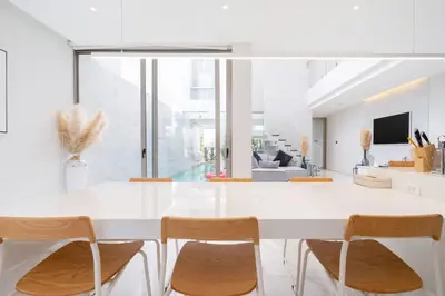 a white dining room with a white table and chairs at Aesthetic 3 Storey Villa Residence A23, Private Pool, close to Ma Doo Bua Café and Laguna in Bang Tao Beach