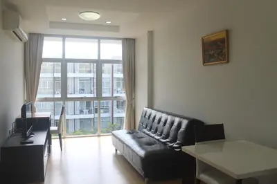a living room with a couch and a large window at Enjoy Krabi and Relax in Klong Muang Beach