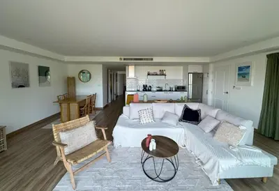 a living room with a white couch and a table at Boho chic sea view apartment in Kata in Kata Beach