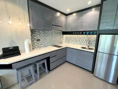 a kitchen with gray cabinets and a sink at Deluxe apartment Citygate Condo by Lofty in Kamala Beach
