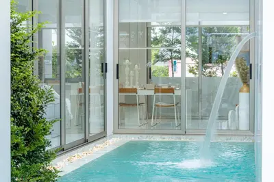 a swimming pool with a fountain in a house at New Modern Aesthetic 3-Storey Villa A15 in Gated Residence just 10 min drive Laguna Phuket in Bang Tao Beach