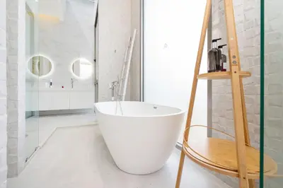 a bathroom with a large white tub in a room at New Modern Aesthetic 3-Storey Villa A15 in Gated Residence just 10 min drive Laguna Phuket in Bang Tao Beach