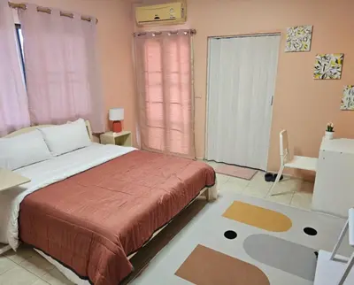 a bedroom with a bed and a large window at Angels 