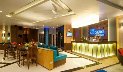 a lobby with a bar and a dining room at The Crystal Beach Hotel in Patong Beach