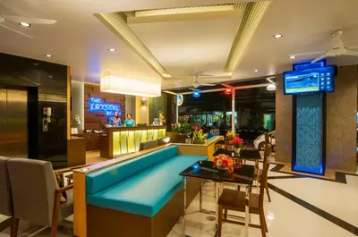 a lobby with a blue couch and a bar at The Crystal Beach Hotel in Patong Beach