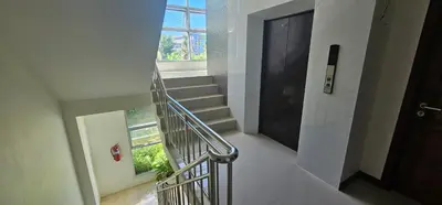 a spiral staircase with a door and a window at The Pano Hotel And Residence in Ao Nang Beach