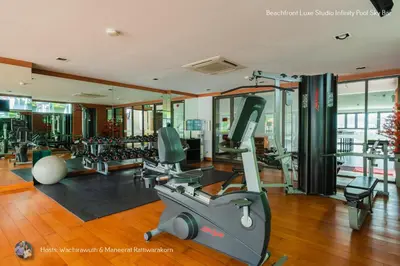 a gym with treadmills and machines in a building at Beachfront Deluxe Infinity Pool in Patong Beach