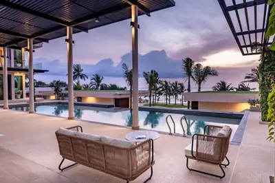 an exterior view of a villa with a swimming pool at Villa Boonta in Phuket Town