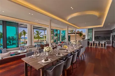 a dining room with a long table and chairs at Villa Boonta in Phuket Town