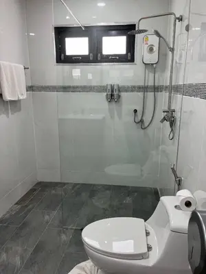 a white bathroom with a toilet and a shower at Peacefully Rawai 3 Bedrooms Pool Villa in Rawai Beach