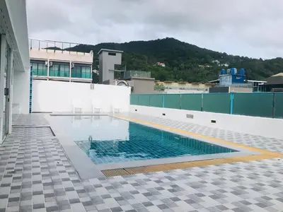 a swimming pool on the side of a building at iCheck inn Central Patong in Patong Beach