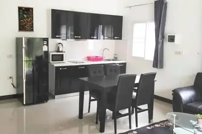 a kitchen with a black table and black chairs at 2 Bedrooms Pool Villa in Kamala in Kamala Beach