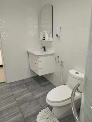 a white bathroom with a toilet and a sink at 2 Bedrooms Pool Villa in Kamala in Kamala Beach