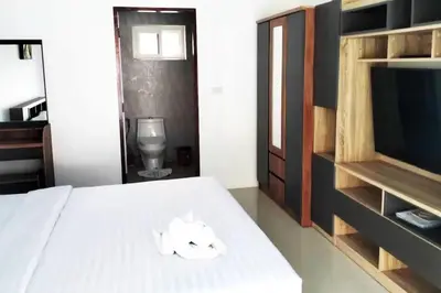 a bedroom with a bed with a tv and towels at 3 Bedrooms Pool Villa in Kamala in Kamala Beach