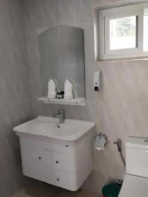 a white bathroom with a sink and a mirror at 3 Bedrooms Pool Villa in Kamala in Kamala Beach