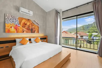 a bedroom with a bed and a large window at Canary Villa - Kamala Beach in Kamala Beach