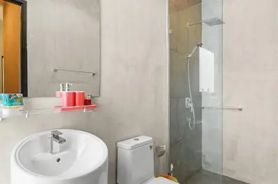 a bathroom with a toilet and a sink and a shower at Canary Villa - Kamala Beach in Kamala Beach