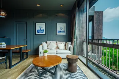 a living room with a couch and a table at Saturdays Residence By JJM in Ban Saiyuan (1)