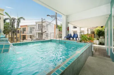 a swimming pool in the middle of a house at Kata Sea Boutique in Kata Beach